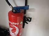 a red fire extinguisor attached to a wall