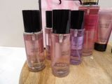 several bottles of perfume sitting on top of a wooden table