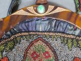a beaded purse with a green bead on it