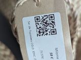 a tag on a piece of woven material that is attached to a chair