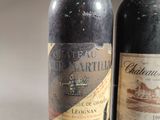 two bottles of wine sitting next to each other on a table
