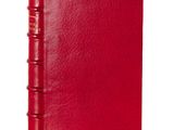 a red leather bound book with a red cover