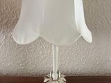 a white lamp that is sitting on a wooden table