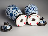 two blue and white vases sitting next to each other