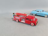 two toy cars sitting next to each other on a table