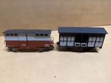 two toy trains sitting side by side on a table