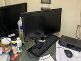 a desk with two monitors, a keyboard, and a mouse on it