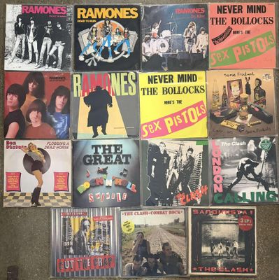 many different records are stacked on top of each other on the floor