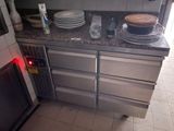 many plates and pans on the counter in the kitchen