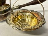 a silver plate with a handle and a bowl on it