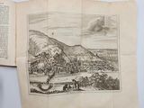 an old book with a picture of a town on it