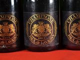 three bottles of wine sitting on top of a red table
