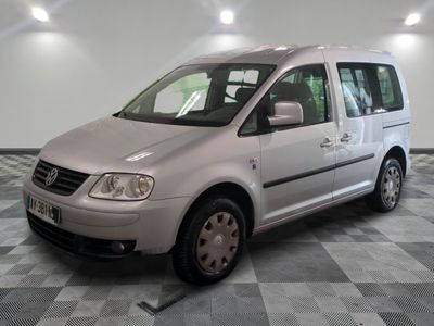 a picture of a silver van parked on a checkered floor