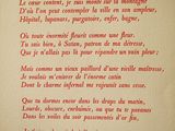 an old book with a poem written in red on it