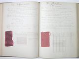an open book with a red and white design on it