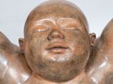 a statue of a man with his hands on his head