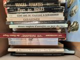many books stacked on top of each other in a box