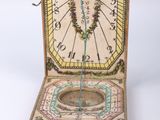 an old wooden box with a clock inside of it on a white surface