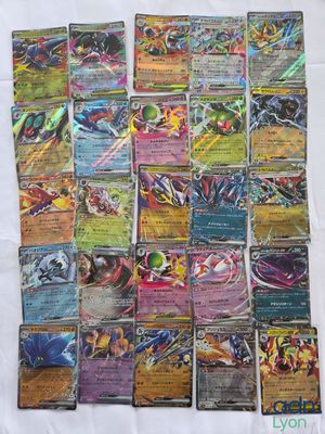 a pile of pokemon cards sitting on top of a table