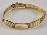 gold plated bracelet with five rows of links on a white surface