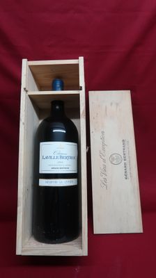 a bottle of wine in a wooden box on a red cloth