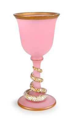 a pink glass with a gold rim and a rope around it