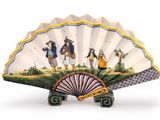 a decorative fan with a painting of people on it