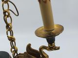 an image of a candle holder with a candle on a chain