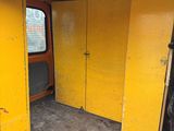 a yellow van that is parked in a garage