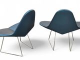 two blue chairs sitting next to each other on a white surface