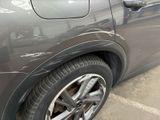 a close up of a car ' s tire on a parking lot