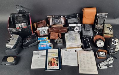 a lot of old cameras and other items on the table