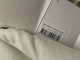 a white box with a barcode on it sitting on a bed