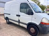 a white van parked in a parking lot next to a building