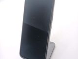 a cell phone that is sitting on top of a stand