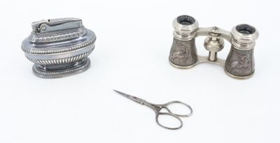 a pair of binoculars and a pair of scissors on a white surface