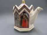 an image of a teapot with a painting of a woman on it