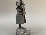 statue of a woman with a book in her hand on a marble base