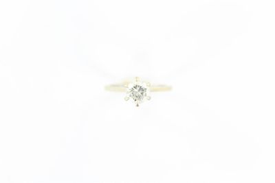 gros plan d'une bague en diamant sur une surface blanche