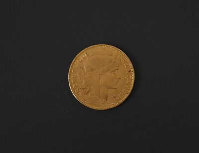 a gold coin on a black surface