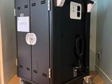 a black locker with a power strip on top of it
