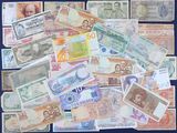 many different types of foreign currency on the table