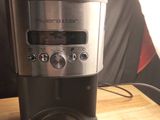 a coffee maker that is sitting on a wooden table