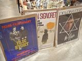 three movie posters on display in a store