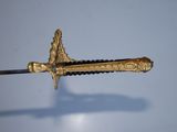 an image of a sword with a gold decoration on it