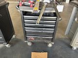a tool cart with tools on top of it in a garage