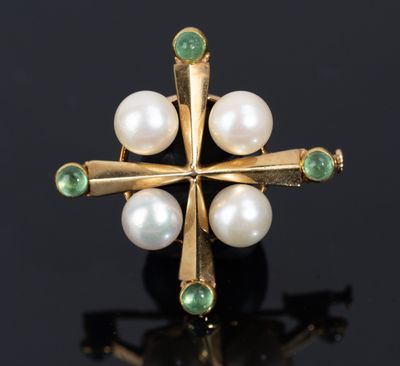 a close up of a gold ring with pearls and emeralds