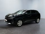 un SUV noir garé dans une pièce aux murs blancs