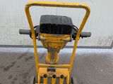 a small yellow machine that is sitting on the ground