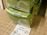 des paquets de papier toilette posés par terre dans une salle de bains